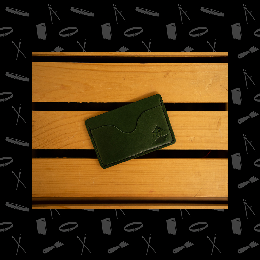 Green horizontal leather wallet with three pockets.