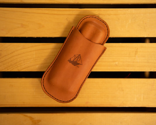Leather cigar case with a logo on a wooden surface